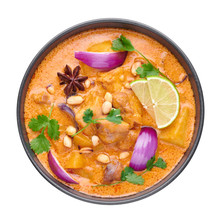 A Chicken Massaman Curry In Black Bowl Isoated On White Background. Massaman Curry Is Thai Cuisine Dish With Chicken Meat, Potato, Onion And Many Spices. Thai Food. Isolate