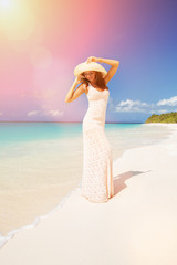 Wall Mural - Fashion woman walking on the beach. Happy island lifestyle. White sand, blue cloudy sky and crystal sea of tropical beach. Vacation at Paradise. Ocean beach relax, travel to Maldives islands