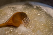 boiling water for pasta with wooden spoon