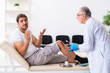 © Elnur - Leg injured man visiting old doctor in first aid concept