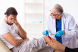 © Elnur - Leg injured man visiting old doctor in first aid concept