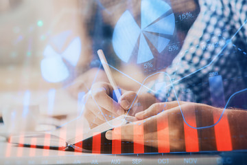 Multi exposure of two men planing investment with stock market forex chart.