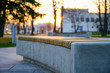 Photo of a city park bench during sunset in the evening