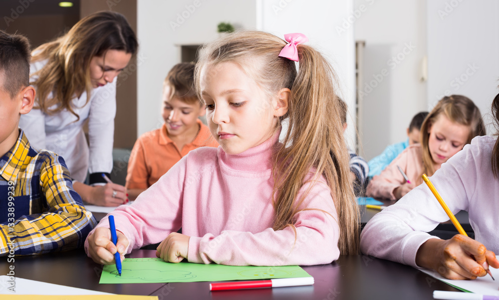 Little children with positive teacher drawing in classroom Stock Photo ...