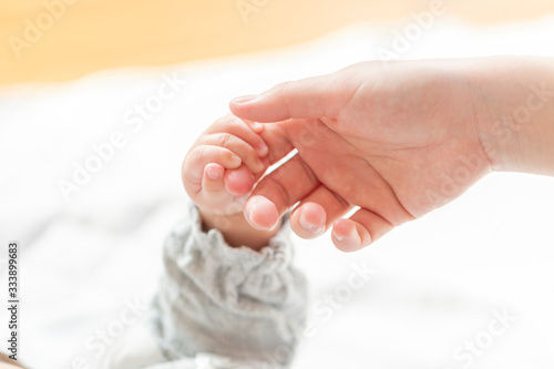 明るい部屋の中で赤ちゃんの手を握る母親の手 Foto De Stock Adobe Stock 明るい部屋の中で赤ちゃんの手を握る母親の手 Foto De Stock Adobe Stock