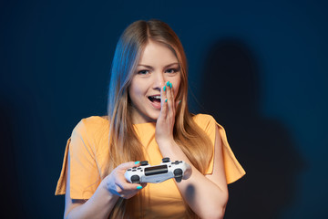 Wall Mural - Excited happy woman playing video game with joystick