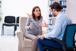 © Elnur - Pregnant woman visiting young male psychologist