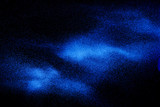 Fototapeta Tęcza - Blue color dust particles explosion cloud on black background.Color powder splash.