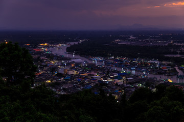 Wall Mural - Pak Nam Chumphon town, fisherman village, and river from Khao Matsee scenic viewpoint during twilight