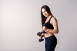 © Ilnur - Strong muscular girl working out with dumbbells. Photo of attractive sporty girl isolated on white background. Strength and motivation