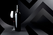 Bottle And Glass Of Red Wine On A Dark Background.