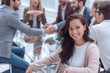 © ASDF - smiling business woman sitting in front of the table in the meeting room