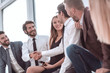 © ASDF - young business people shaking hands while sitting in the office lobby