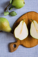 Wall Mural - pears in a plate and slices of pears top view. wooden background with pears