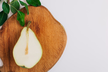 Wall Mural - pears in a plate and slices of pears top view. wooden background with pears