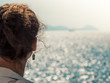 © WineDonuts - Young woman with sunglasses enjoying the breeze on a ship travel at sea.