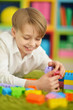 © aletia2011 - Cute little boy playing with colorful plastic blocks