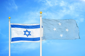 Israel and Micronesia two flags on flagpoles and blue cloudy sky