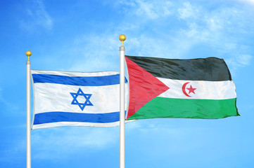 Israel and Western Sahara two flags on flagpoles and blue cloudy sky