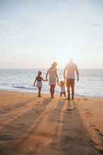 Holiday Travel Concept, Summer Vacations. Happy Family Are Having Fun On A Tropical Beach In Sunset.