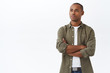 © Cookie Studio - Portrait of serious-looking determined young african-american man, looking with focused thoughtful expression at left side copy space, cross arms chest confident, ready for action, white background