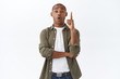 © Cookie Studio - Got suggestion, listen. Portrait of excited creative, smart african american man sharing his thought, raise index finger eureka sign, telling idea, think-up good plan, white background