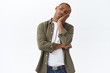 © Cookie Studio - Portrait of bored african-american man, lean face on palm, staring with indifferent and boredom left, watching tv at home during quarantine, dont know what do, feel sad, white background