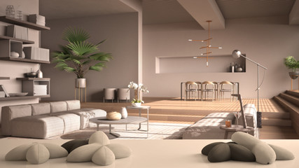 White table, desk or shelf with five soft white pillows in the shape of stars or flowers, over modern living room in beige tones, open space, architecture interior design concept