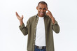 © Cookie Studio - Are you dumb or what. Portrait of arguing annoyed and frustrated african-american man pointing left at disappointing messed-up chart, touching temple, scolding crazy stupid person
