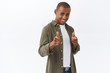 © Cookie Studio - Portrait of lucky confident african american man congratulate person, pointing finger pistols camera, smiling assured, encourage apply for this job, join company, picking person, white background