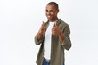 © Cookie Studio - Grab your chance, its you. Portrait of lucky confident and happy young handsome african-american man encourage or praise someone good job, show thumb-up, recommend product