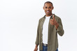 © Cookie Studio - Nice work, proud of you. Portrait of satisfied handsome african-american man, show thumb-up in approval, like choice, recommend company service, leave positive feedback, white background