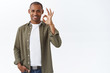 © Cookie Studio - Good quality, guarantee you like it. Portrait of confident african-american man show okay, ok sign and smiling, nod in approval, give positive feedback, approve and agree, white background