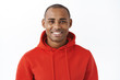 © Cookie Studio - Close-up portrait of healthy good-looking african-american man in red hoodie, staying optimistic, having faith all be good, smiling pleased and enthusiastic, standing white background joyful