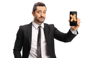 Sticker - Young man in a suit showing a mobile phone with aid bands on the screen