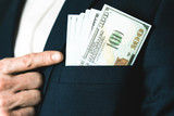 Fototapeta  - Money success concept. 100 dollar bills in businessman jacket pocket. Symbol of success and wealth.