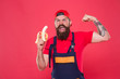 © be free - Fresh vitamins. Tasty food. Bite banana. Hungry hipster. Favorite snack. Lunch time. Bearded man in uniform and cap eating banana. Worker builder mechanic eat banana. Fresh fruit. Living healthy life