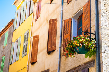 Old architecture in Valensole, Provence, France. Stone houses and windows with wooden shutters