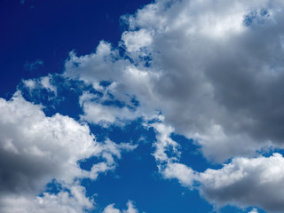 white puffy clouds in a bright blue sky