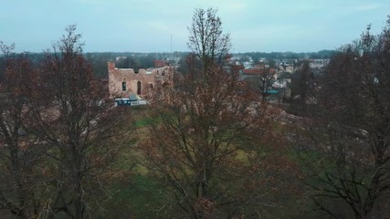 Wall Mural - Aerial Drone View Dobele Medieval Castle  the Town of Dobele on the West Bank of the River Berze, in the Historical Region of Zemgale, in Latvia. Ruins of an Ancient Medieval Castle Dobele Latvia.