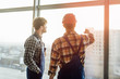 © Тарас Нагирняк - Two man builder, engineer standing at the window and talking about job.