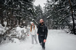 © Andrii - Couple playing with snow in the forest