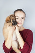 © Natalya Antoshchenko - Golden retriever puppy in the arms of a teenage girl.