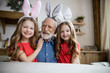 © Yakobchuk Olena - Happy relatives wearing bunny ears and laughing stock photo