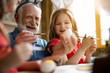 © Yakobchuk Olena - Excited grandfather and granddaughter painting eggs stock photo