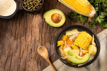 Colombian ajiaco soup prepared with chicken, potatoes, cob and guasca leaves