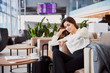 © Yakobchuk Olena - Beautiful lady checking time in airport waiting room