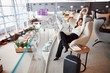 © Yakobchuk Olena - Smiling young woman resting in airport waiting room