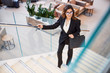 © Yakobchuk Olena - Gorgeous young woman climbing stairs in business center