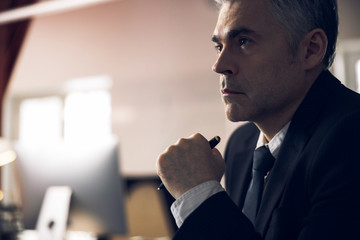 Caucasian man in suit working at computer indoors